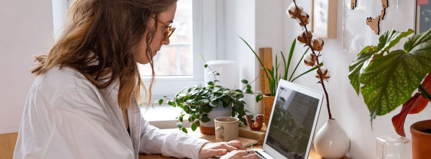 Junge Frau lernt zuhause am Laptop für ihre Heilpraktiker Prüfung
